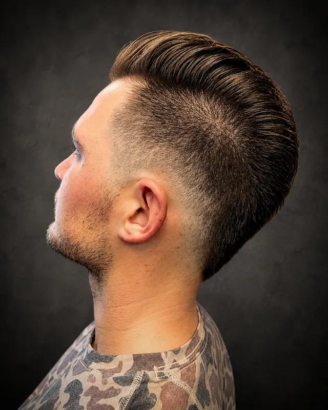 Client with a slick fade haircut by Tami Lee